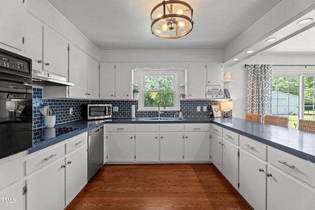 12082 NC-42, Fuquay Varina, NC 27526 - kitchen featuring black appliances, under cabinet range hood, a chandelier, and healthy amount of natural light