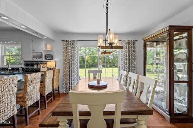 12082 NC-42, Fuquay Varina, NC 27526 - dining area featuring a chandelier, healthy amount of natural light, light wood-type flooring, crown molding, and recessed lighting