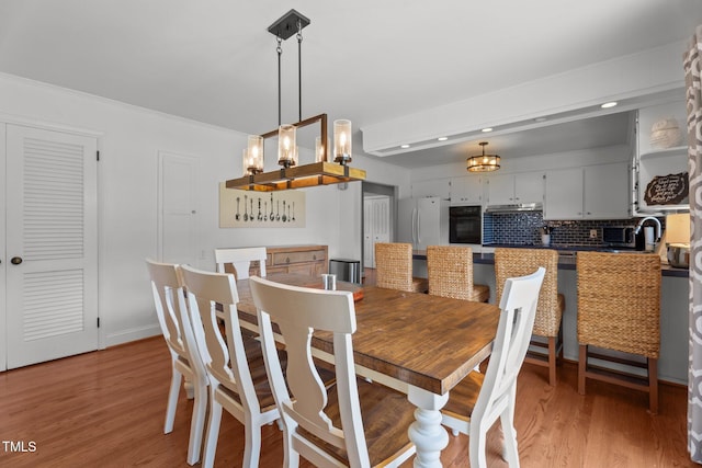 12082 NC-42, Fuquay Varina, NC 27526 - dining space with a chandelier, light wood finished floors, recessed lighting, and ornamental molding