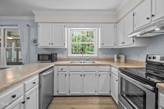 3007 Appling Way, Durham, NC 27703 - kitchen featuring appliances with stainless steel finishes, under cabinet range hood, crown molding, white cabinetry, and light countertops