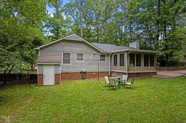3007 Appling Way, Durham, NC 27703 - back of property with a chimney, a fenced backyard, a sunroom, and crawl space