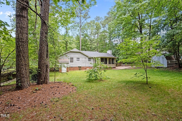 3007 Appling Way, Durham, NC 27703 - view of grassy yard featuring a shed and a sunroom