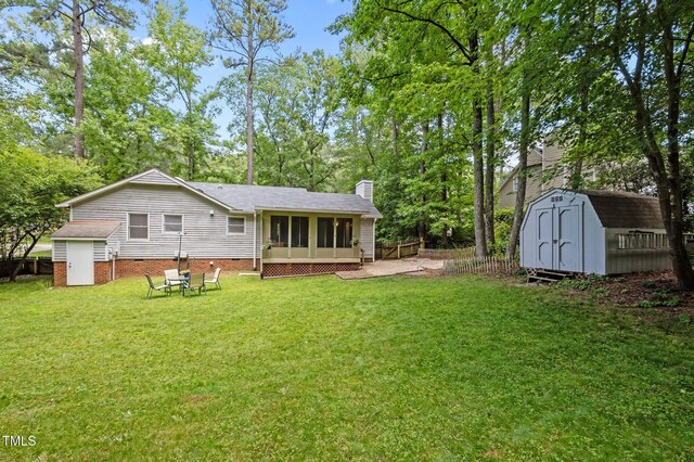 3007 Appling Way, Durham, NC 27703 - rear view of house with a storage unit, a sunroom, and a chimney
