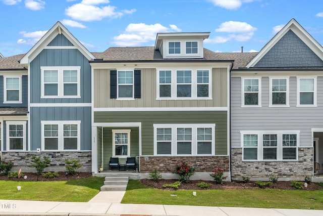 937 Baldwin Ridge Rd, Apex, NC 27523 - townhome / multi-family property with board and batten siding, stone siding, roof with shingles, and a front yard