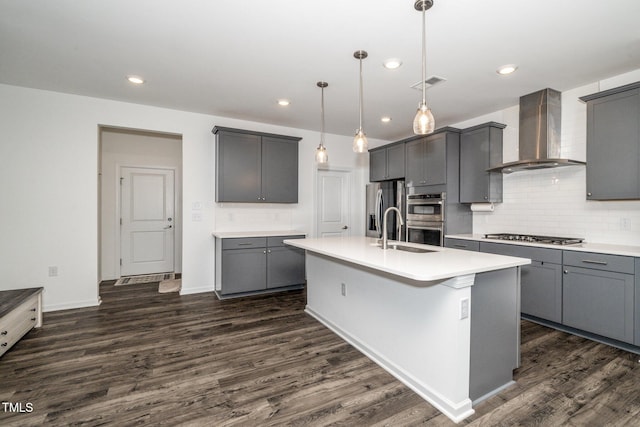 937 Baldwin Ridge Rd, Apex, NC 27523 - kitchen featuring wall chimney range hood, appliances with stainless steel finishes, dark wood-type flooring, decorative backsplash, and recessed lighting