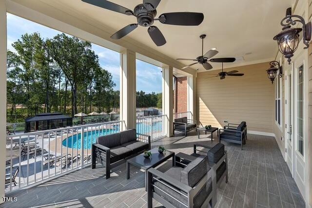 937 Baldwin Ridge Rd, Apex, NC 27523 - view of patio with outdoor lounge area, a ceiling fan, and a community pool