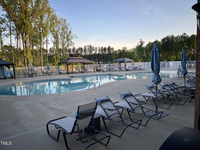 937 Baldwin Ridge Rd, Apex, NC 27523 - community pool with a gazebo, view of scattered trees, and a patio