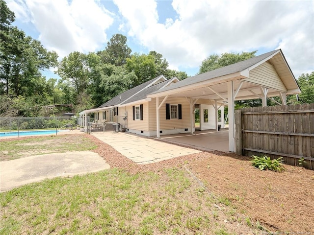 1554 Locklear Rd, Pembroke, NC 28372 - back of house with a patio and a carport