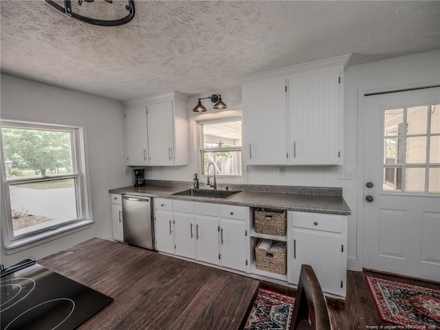 1554 Locklear Rd, Pembroke, NC 28372 - kitchen with dishwasher, cooktop, dark wood finished floors, healthy amount of natural light, and a textured ceiling