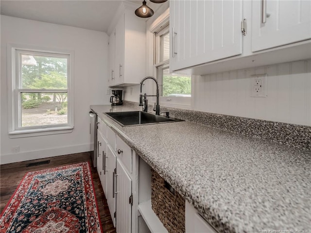 1554 Locklear Rd, Pembroke, NC 28372 - kitchen with dark wood-style flooring, white cabinets, light countertops, and stainless steel dishwasher