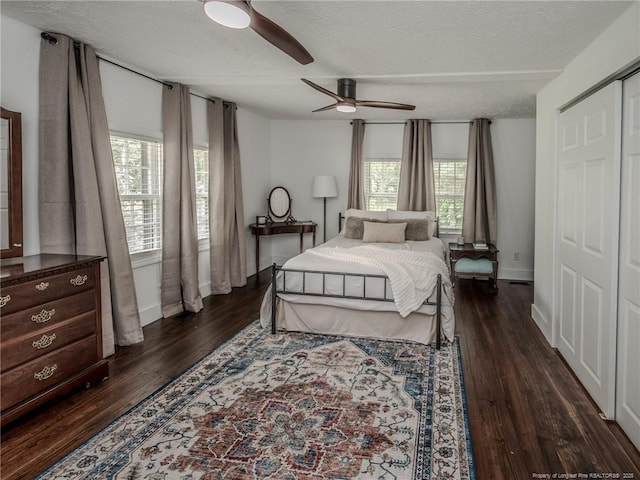 1554 Locklear Rd, Pembroke, NC 28372 - bedroom featuring multiple windows, dark wood-type flooring, a textured ceiling, and ceiling fan