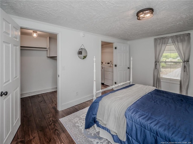 1554 Locklear Rd, Pembroke, NC 28372 - bedroom with washing machine and dryer, a textured ceiling, a spacious closet, wood-type flooring, and a closet