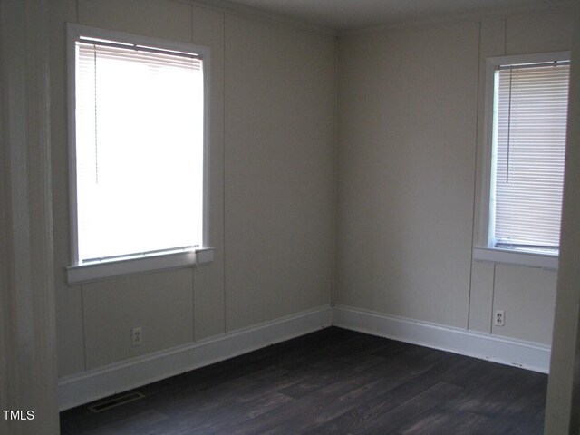 3514 S Alston Ave, Durham, NC 27713 - unfurnished room featuring dark wood-style floors, plenty of natural light, and crown molding