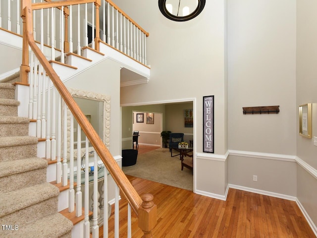 1005 Fairfax Woods Dr, Apex, NC 27502 - staircase with wood finished floors and a towering ceiling