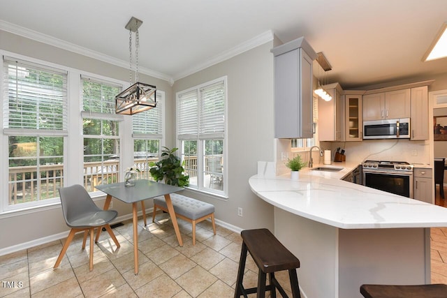 1005 Fairfax Woods Dr, Apex, NC 27502 - kitchen with stainless steel appliances, plenty of natural light, a kitchen bar, crown molding, and glass insert cabinets