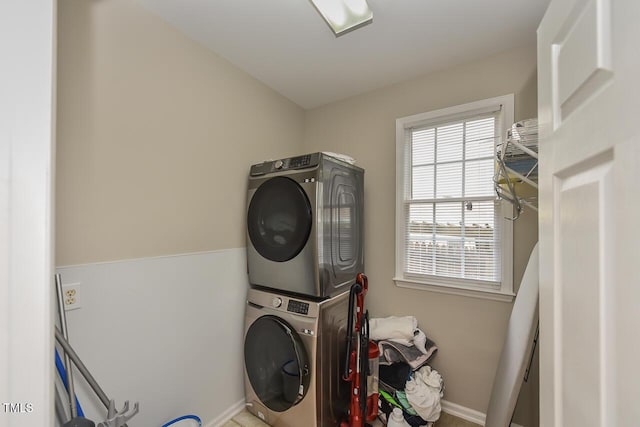 1005 Fairfax Woods Dr, Apex, NC 27502 - laundry area featuring stacked washing machine and dryer and baseboards
