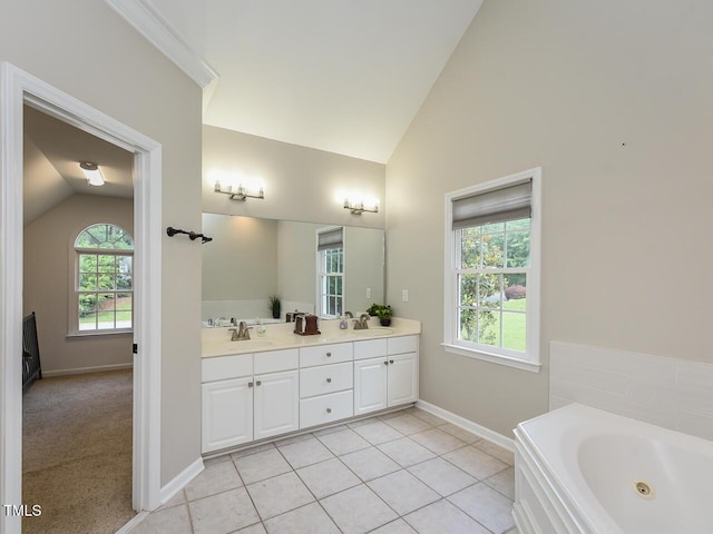 1005 Fairfax Woods Dr, Apex, NC 27502 - bathroom with vaulted ceiling, double vanity, healthy amount of natural light, a jetted tub, and tile patterned flooring