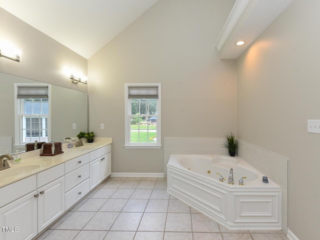 1005 Fairfax Woods Dr, Apex, NC 27502 - bathroom featuring double vanity, plenty of natural light, a tub with jets, tile patterned flooring, and high vaulted ceiling