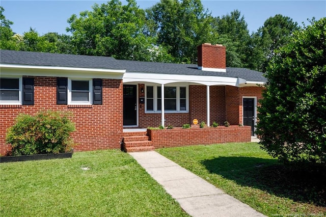 106 N 3rd St, Maxton, NC 28364 - ranch-style house featuring a chimney, a front yard, and brick siding