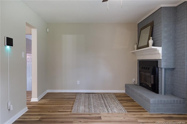 106 N 3rd St, Maxton, NC 28364 - unfurnished living room featuring wood finished floors and a fireplace