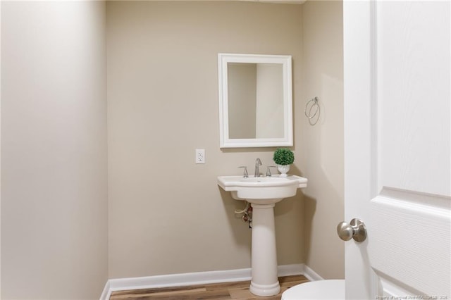 106 N 3rd St, Maxton, NC 28364 - half bathroom featuring toilet and wood finished floors