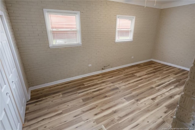 106 N 3rd St, Maxton, NC 28364 - unfurnished room with wood finished floors and brick wall
