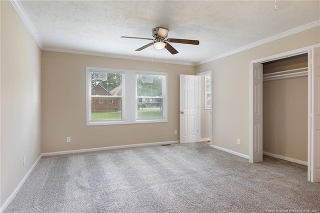106 N 3rd St, Maxton, NC 28364 - unfurnished bedroom with carpet floors, a textured ceiling, crown molding, ceiling fan, and a closet