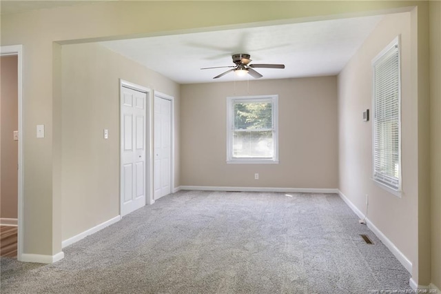 106 N 3rd St, Maxton, NC 28364 - unfurnished bedroom featuring carpet flooring and ceiling fan