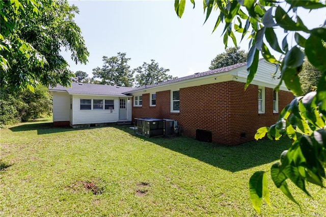 106 N 3rd St, Maxton, NC 28364 - rear view of house featuring crawl space, a yard, a jacuzzi, and brick siding