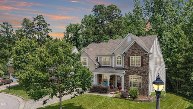 534 Siltstone Pl, Cary, NC 27519 - view of front of home featuring stone siding, a front yard, and covered porch