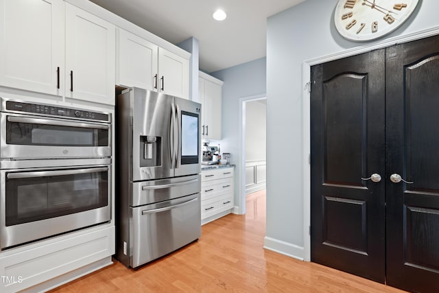 534 Siltstone Pl, Cary, NC 27519 - kitchen with stainless steel appliances, light wood-type flooring, white cabinets, and recessed lighting