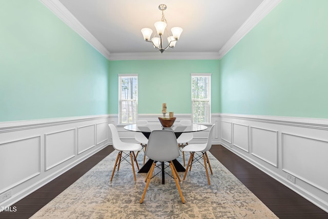3504 Regent Pines Dr, New Hill, NC 27562 - dining area with dark wood-style floors, a chandelier, crown molding, and a wainscoted wall