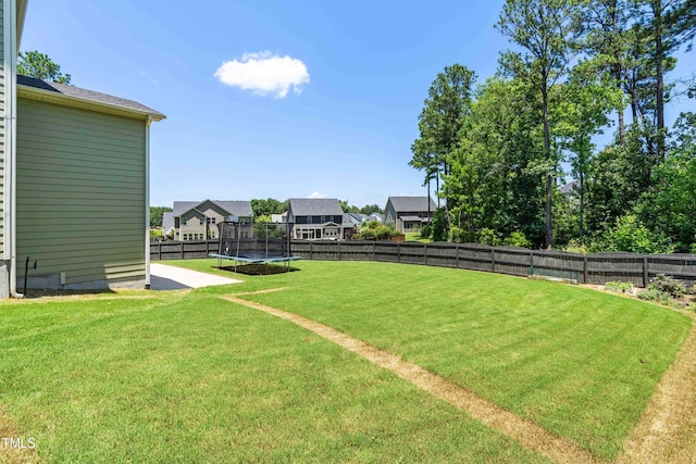 3504 Regent Pines Dr, New Hill, NC 27562 - fenced backyard with a trampoline and a residential view