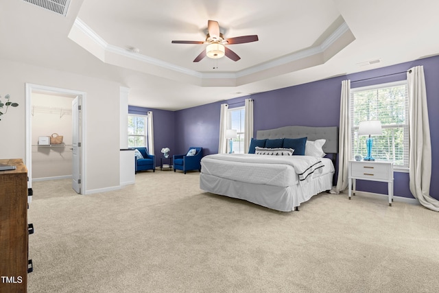 3504 Regent Pines Dr, New Hill, NC 27562 - bedroom with a tray ceiling, carpet, ornamental molding, ceiling fan, and a spacious closet