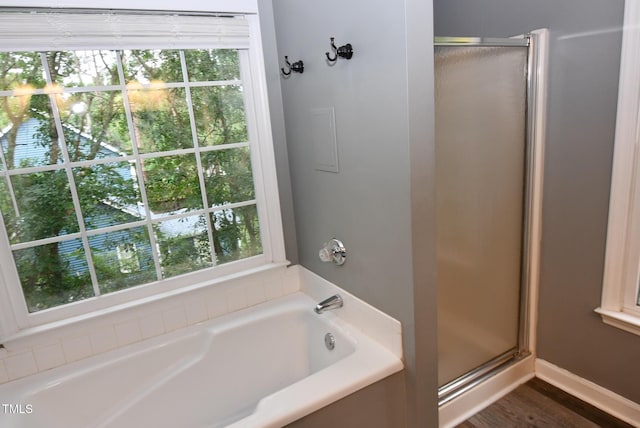 3209 Leebrook Rd, Raleigh, NC 27616 - bathroom featuring a stall shower, a bath, and wood finished floors
