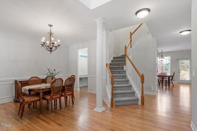 3921 Robins Nest Ln, Wake Forest, NC 27587 - dining room with a chandelier, stairway, light wood-type flooring, a wainscoted wall, and crown molding