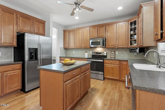 3921 Robins Nest Ln, Wake Forest, NC 27587 - kitchen with stainless steel appliances, light wood-style floors, decorative backsplash, glass insert cabinets, and recessed lighting
