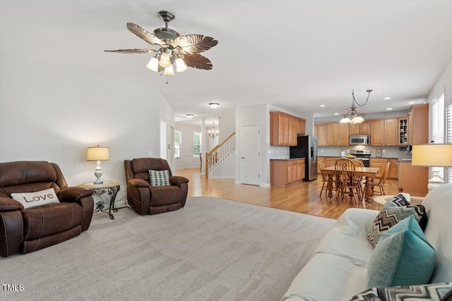 3921 Robins Nest Ln, Wake Forest, NC 27587 - living room with a chandelier, recessed lighting, stairs, light wood-style flooring, and ceiling fan
