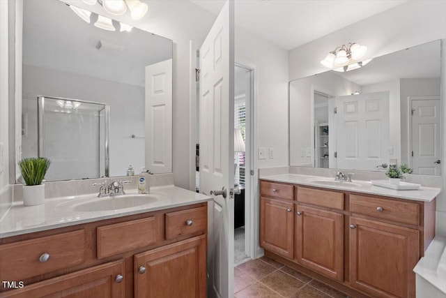 3921 Robins Nest Ln, Wake Forest, NC 27587 - bathroom with two vanities, a stall shower, and tile patterned floors