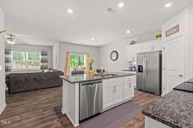 2730 Spring Valley Dr, Creedmoor, NC 27522 - kitchen featuring appliances with stainless steel finishes, dark stone countertops, an island with sink, white cabinetry, and recessed lighting