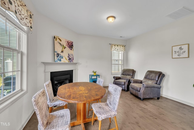 48 Manito Pl, Clayton, NC 27520 - dining room with a glass covered fireplace and wood finished floors