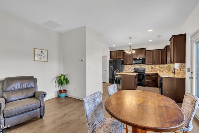 48 Manito Pl, Clayton, NC 27520 - dining space with light wood-style flooring, recessed lighting, and a chandelier