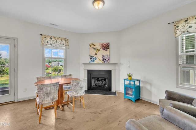 48 Manito Pl, Clayton, NC 27520 - dining space with wood finished floors and a fireplace with flush hearth