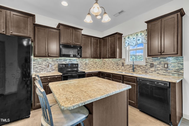 48 Manito Pl, Clayton, NC 27520 - kitchen featuring black appliances, dark brown cabinetry, a kitchen island, a chandelier, and hanging light fixtures