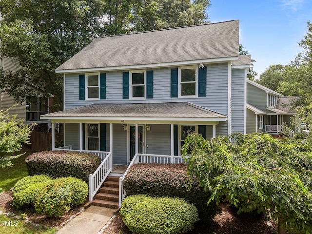 112 Autumn Ridge Dr, Knightdale, NC 27545 - view of front facade with a porch, a shingled roof, and cooling unit