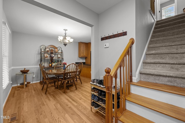 112 Autumn Ridge Dr, Knightdale, NC 27545 - dining area with stairway, light wood-type flooring, and a chandelier