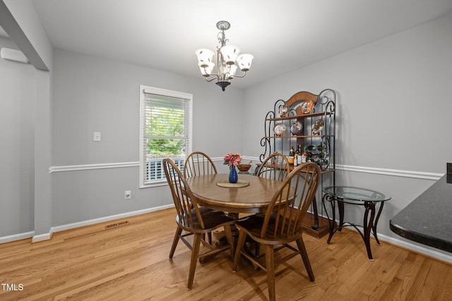 112 Autumn Ridge Dr, Knightdale, NC 27545 - dining area with a chandelier and wood finished floors