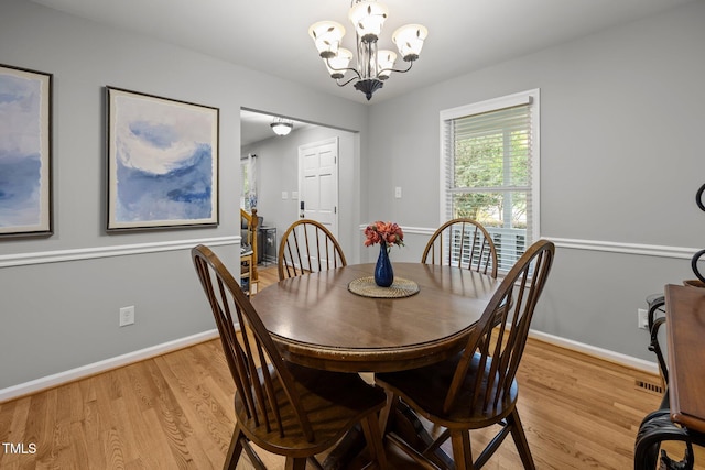 112 Autumn Ridge Dr, Knightdale, NC 27545 - dining area featuring light wood finished floors and a chandelier