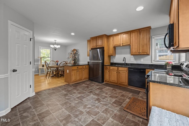 112 Autumn Ridge Dr, Knightdale, NC 27545 - kitchen with black appliances, a chandelier, a peninsula, recessed lighting, and dark stone finish flooring
