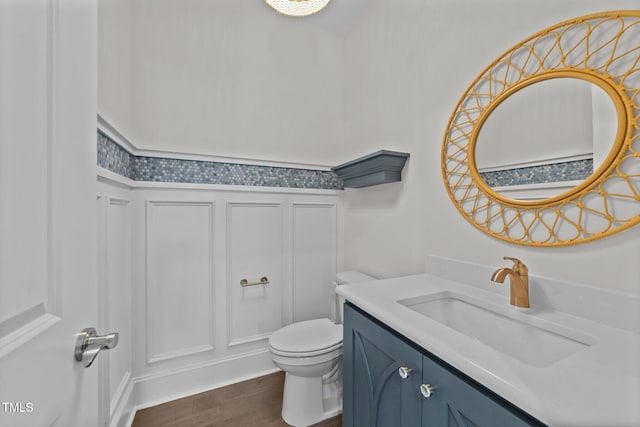 543 Allessandra Dr, Clayton, NC 27527 - bathroom featuring a decorative wall, vanity, wood finished floors, and a wainscoted wall